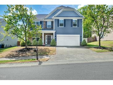 Charming two-story home featuring a two-car garage, well-maintained landscaping, and inviting curb appeal at 416 Glenview Ln, Durham, NC 27703