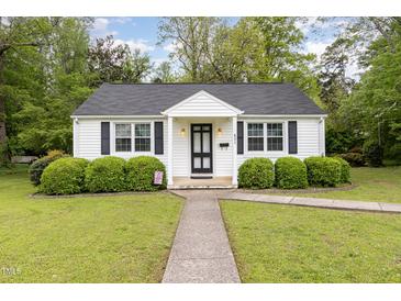 Charming home featuring a well-manicured lawn, black shutters and neatly trimmed shrubs enhancing its curb appeal at 431 Waddill St, Henderson, NC 27536