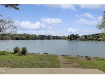 Expansive lake view from the property with a grassy shoreline and wooden steps at 512 N Waters Edge Dr, Durham, NC 27703