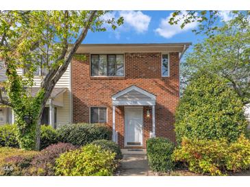 Charming brick townhouse featuring a covered entryway and well-manicured landscaping at 5900 Shady Grove Cir, Raleigh, NC 27609