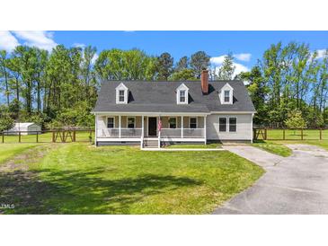 Charming home featuring a welcoming front porch, dormer windows, and a well-maintained front yard at 8700 Crowder Rd, Raleigh, NC 27603