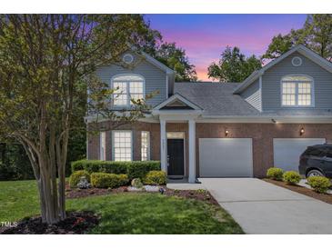 Charming brick home featuring a well-manicured lawn, two-car garage, and inviting front porch at 9005 River Estates Dr, Knightdale, NC 27545