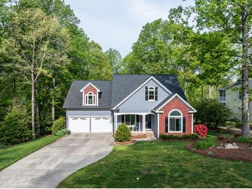 Charming home featuring a two-car garage, beautiful landscaping, and a well-maintained lawn at 105 Hein Dr, Clayton, NC 27527