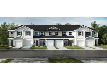 New townhome construction featuring multi-tone exteriors, attached garages, and professionally landscaped front lawns at 10573 Brookside Reserve St, Raleigh, NC 27614