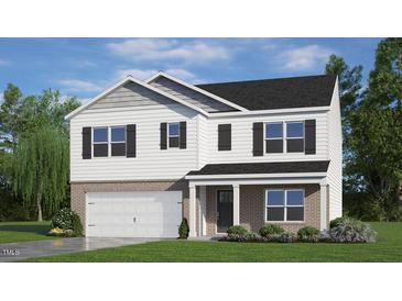 Two-story home featuring a brick foundation, white siding, black shutters, and a neatly manicured lawn at 138 Fair Child Rd, Spring Lake, NC 28390