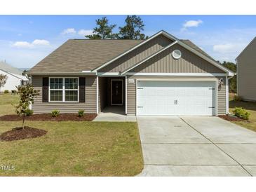 Charming single-story home featuring neutral siding, a two-car garage, and a well-manicured lawn at 2040 Alderman Way, Creedmoor, NC 27522
