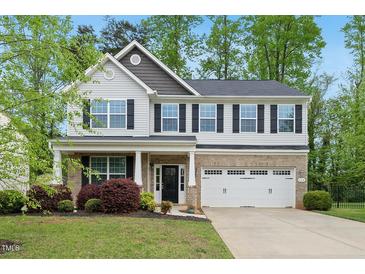 Charming two-story home with well-maintained landscaping and a two-car garage at 226 Fair Oaks Ct, Mebane, NC 27302