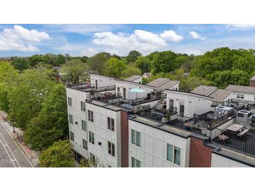Modern townhome exterior with rooftop terraces, black railings, and brick accents at 400 W Rosemary St # 104, Chapel Hill, NC 27516