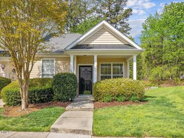 Inviting single-story home featuring a quaint front porch and well-maintained landscaping at 522 Auburn Square Dr, Durham, NC 27713