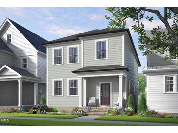 Charming two-story home with inviting front porch and well-maintained landscaping at 524 Folk Song Way, Wendell, NC 27591