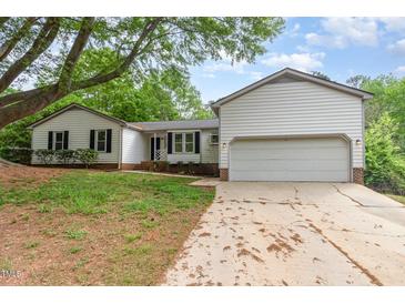 Charming two-story home featuring a two-car garage and a beautifully landscaped front yard at 5604 Groomsbridge Ct, Raleigh, NC 27612