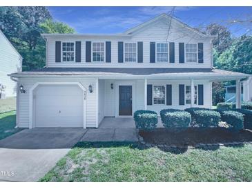 Charming two-story home with a front yard, attached garage and dark shutters at 5828 Brambleton Ave, Raleigh, NC 27610