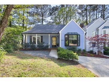Charming blue home with a cozy front porch and lush landscaping at 6 Landover Ct, Durham, NC 27713