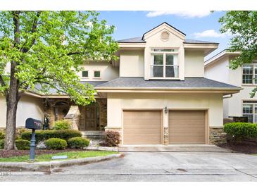 Charming two-story home with a stone-accented entrance, two-car garage, and mature landscaping at 97302 Dobbs, Chapel Hill, NC 27517