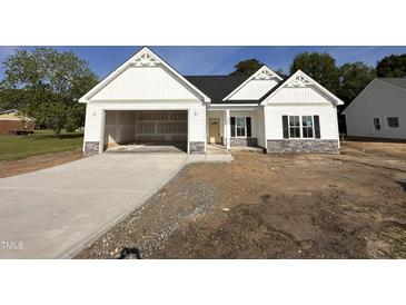 Charming new home with a welcoming entrance and attached garage, perfect for modern living at 1008 Peedin Rd, Selma, NC 27576