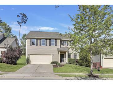 Charming two-story home features a well-maintained front yard and a convenient two-car garage, creating a welcoming curb appeal at 1016 Leatherstone Ln, Fuquay Varina, NC 27526