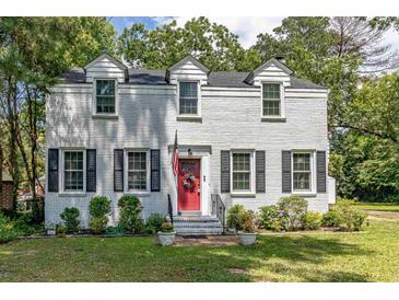 Charming two-story brick home with a bright red front door and neatly landscaped front yard at 1106 Sycamore St, Rocky Mount, NC 27801