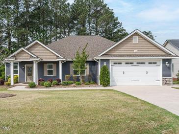 Charming single Gathering home with two-car garage and landscaped front yard at 125 Claymore Dr, Clayton, NC 27527