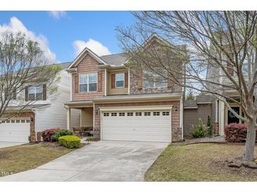 Charming two-story home with a two car garage, stone accents, and manicured lawn at 140 Torrey Heights Ln, Durham, NC 27703
