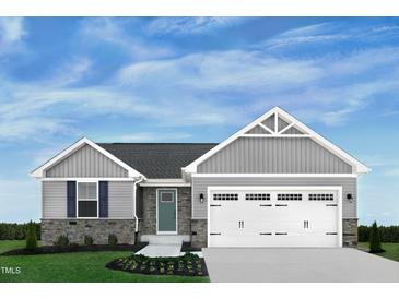 Charming single-Gathering home featuring stone accents, a two-car garage, and beautifully landscaped front yard at 16 Saintsbury Dr, Fuquay Varina, NC 27526
