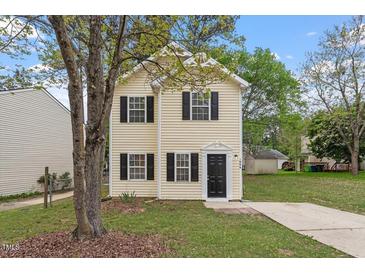 Charming two-story home with a manicured lawn and inviting entrance, perfect for a growing Gathering or first-time buyers at 1808 Elkpark Dr, Raleigh, NC 27610