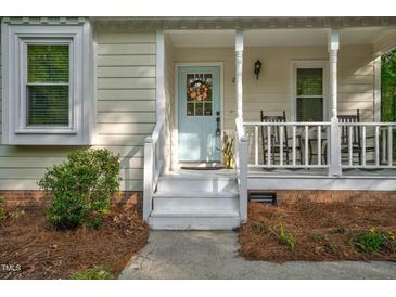 Charming home featuring a light blue front door with a decorative wreath and a welcoming porch at 2108 Canterbury Rd, Clayton, NC 27520