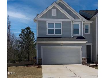 Charming two-story home with a two-car garage and a well-maintained lawn at 2137 Caen St, Raleigh, NC 27610