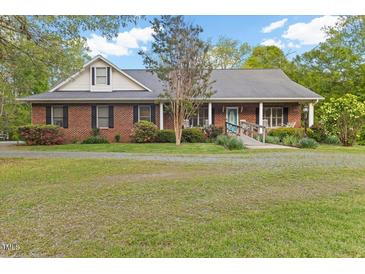 Charming brick home with a welcoming front porch and well-maintained landscaping at 2456 Nealwood Ave, Graham, NC 27253