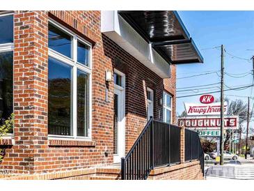 Charming brick building with a modern awning and close proximity to local shops at 256 William Drummond Way, Raleigh, NC 27604