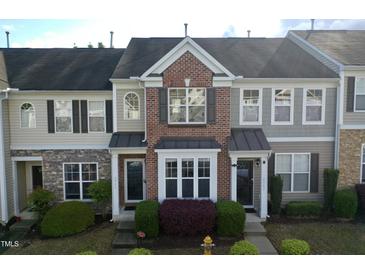 Charming multi-story townhome with brick accents and manicured landscaping at 2945 Casona Way, Raleigh, NC 27616