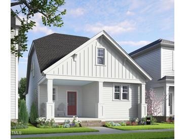 Charming exterior elevation of a two-story home with a welcoming front porch and landscaped yard at 528 Folk Song Way, Wendell, NC 27591