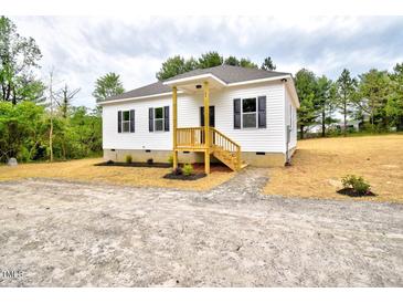 Charming single-story home with white siding, black shutters, and a cozy front porch at 68 S Grace Way, Henderson, NC 27537