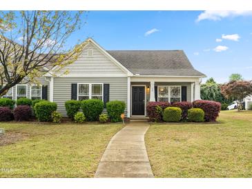 Charming single-story home with a well-manicured lawn and colorful landscaping at 72 E Moss Creek Dr, Clayton, NC 27520