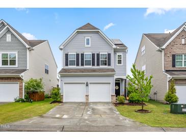 Charming two-story home with a two-car garage, landscaped yard, and welcoming front porch at 1018 Sweet Cream Ct, Durham, NC 27703