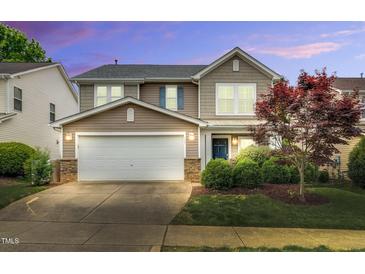 Inviting two-story home with a two car garage and beautifully landscaped front yard at 105 Ryder Cup Cir, Raleigh, NC 27603