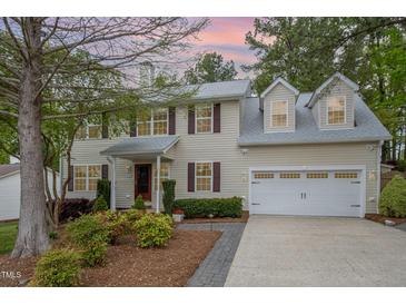 Charming two-story home with brick accents, dormer windows, and a well-manicured lawn at 1208 Lexington Farm Rd, Apex, NC 27502