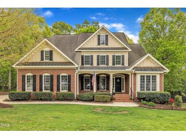 Charming two-story brick home with manicured lawn and landscaping at 124 Mantle Dr, Clayton, NC 27527