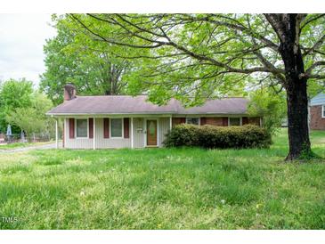 Charming single-story home with a cozy front porch and a large tree in the front yard at 133 Montree Ln, Graham, NC 27253