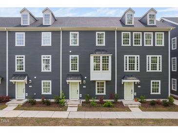 Charming townhome with gray siding, multiple windows and light green doors at 139 Callowhill Ln, Durham, NC 27713