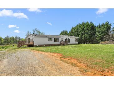 Charming single-story home with a covered porch and well-maintained lawn at 1729 Crawford Rd, Graham, NC 27253