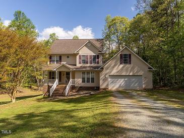 Charming two-story home with a well-manicured lawn and a two car garage at 1850 Crissy Ln, Graham, NC 27253