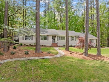Charming ranch-style home with a stone pathway leading to the front door and lush landscaping at 2805 Chelsea Cir, Durham, NC 27707