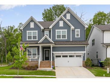 Beautiful two-story home with a manicured lawn, a two-car garage, and an inviting front porch at 33 Highpointe Dr, Pittsboro, NC 27312