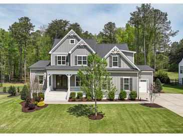 Beautiful two-story home featuring a landscaped front yard and charming front porch at 3545 Donlin Dr, Wake Forest, NC 27587