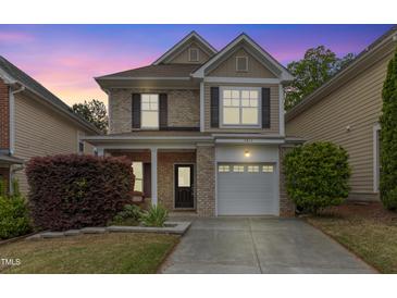 Charming two-story home with brick and siding, featuring a driveway and well-maintained landscaping at 3811 Yates Mill Trail, Raleigh, NC 27606
