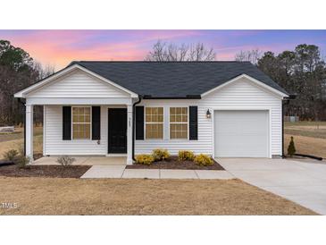 Charming single-story home with white siding, black shutters, and a well-maintained front yard at 385 Dasu Dr, Clayton, NC 27520