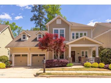 Charming two-story home with a well-manicured lawn, two-car garage, and inviting front porch at 43 Turtle Point Bnd, Chapel Hill, NC 27516