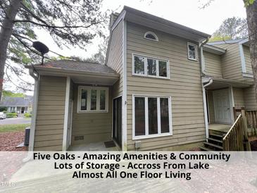 Two-story home features a neutral color scheme, ample windows, a covered patio, and mature trees at 4420 Beechnut Ln, Durham, NC 27707