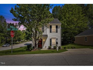 Charming two-story home with a well-maintained lawn and mature trees at 5801 Forest Point Rd, Raleigh, NC 27610