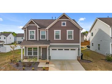 Charming two-story home featuring a 2-car garage and meticulously maintained landscaping at 7205 Tillage Rd, Mebane, NC 27302